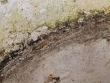 a close up view of a dirty pipe with water coming out of it