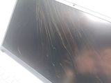 a broken laptop screen sitting on top of a desk