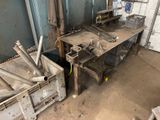a metal workbench with a bunch of tools on it