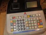 an image of a cash register with a note attached to it