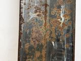 a piece of metal with rust on it sitting on a table