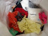 a bag full of clothes that is sitting on a bed