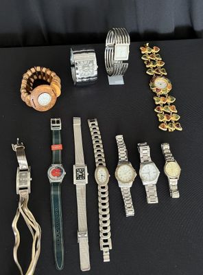 a lot of watches and bracelets on a table
