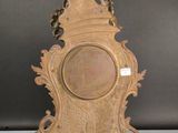 an image of a wooden clock on a stand with a bird on it