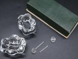 three glass dishes and a book on a table