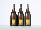 three bottles of wine sitting on top of a table next to each other