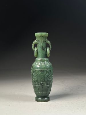 a green vase that is sitting on a table