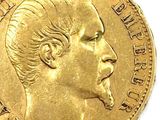 a close up of a gold coin with a man ' s face on it