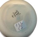 a white frisbee that has a sticker on it