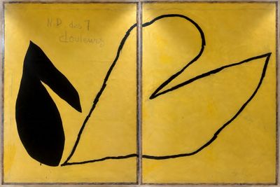 yellow and black paintings on a wall in a room