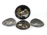 three black and white plates with designs on them sitting on a white surface