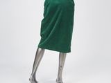 a mannequin wearing a green skirt and black top