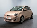 the small car is parked in the large room of the building