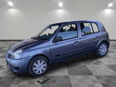 a picture of a small blue car parked in a garage