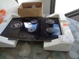 a box on top of a stove that is sitting on a table