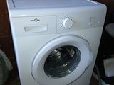 a washing machine that is sitting in the corner of a room