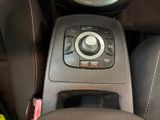 a close up of a car ' s center console and steering wheel