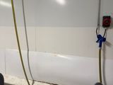 a picture of a bathroom with a tub and a hose