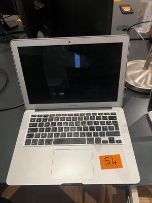 a laptop computer sitting on a desk with a price tag on it