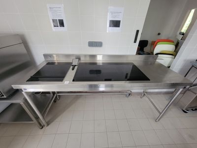 une cuisine en acier inoxydable équipée d'une cuisinière et d'un évier