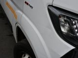 a close up of a white truck parked on the side of the road