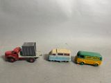 three toy trucks sitting next to each other on a table