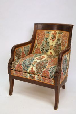a chair that has a colorful upholstered seat on it