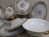 a lot of plates and bowls sitting on a table