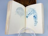 an open book with a drawing of a man on it