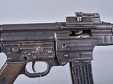 an old machine gun with a metal barrel on a white background