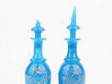 pair of blue glass vases with gold designs on them