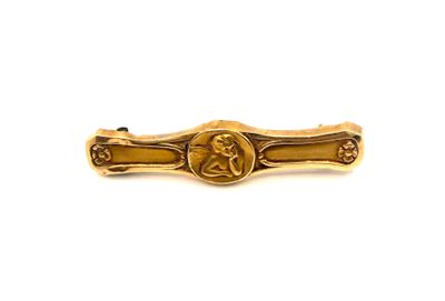 an image of a gold tie bar with a picture of a man on it