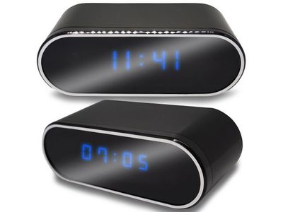 an image of two black alarm clocks with blue numbers on them