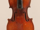 an old violin sitting on top of a white surface