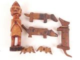 several pieces of carved wood are arranged on a white surface