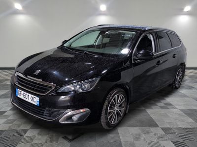 the black car is parked on a checkered floor in the garage