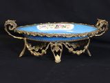 an antique blue and gold plate with a floral design on it