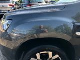 a man taking a picture of himself in the reflection of a car