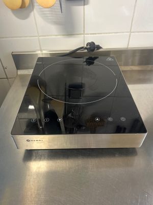 stainless steel counter top with a black burner on top of it