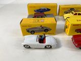three toy cars are sitting next to each other on a table