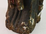 a statue of a man sitting on top of a tree stump