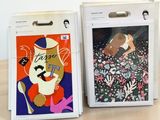 two boxes with pictures on them sitting on a table