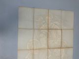 painting of a man riding a motorcycle on a tile wall