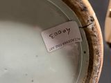a white plate with a tag on it sitting on a table