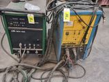 two welding machines that are sitting on the ground
