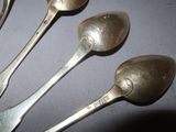 four spoons that are sitting next to each other on a table