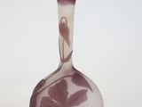 a vase with a bird on it sitting on a table