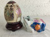two ceramic animals sitting next to each other on a table