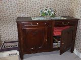 a wooden cabinet with a door open in a room