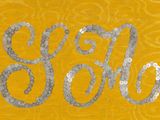 a close up of a yellow and silver sign with the word go on it